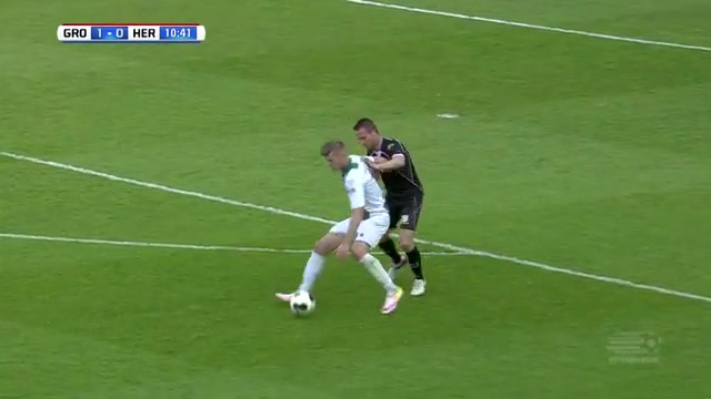 Speler van FC Groningen in groen-wit shirt schermt de bal af langs de zijlijn